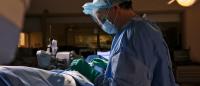 Dr. John Abbott wearing scrubs and preparing for surgery.